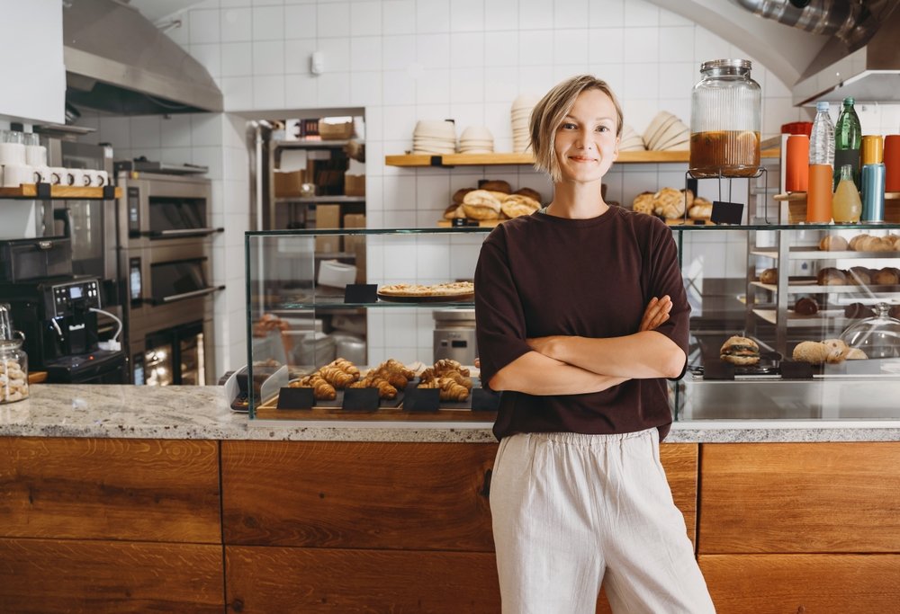 Portrait,Of,Smiling,Young,Woman,Entrepreneur,Standing,At,The,Counter